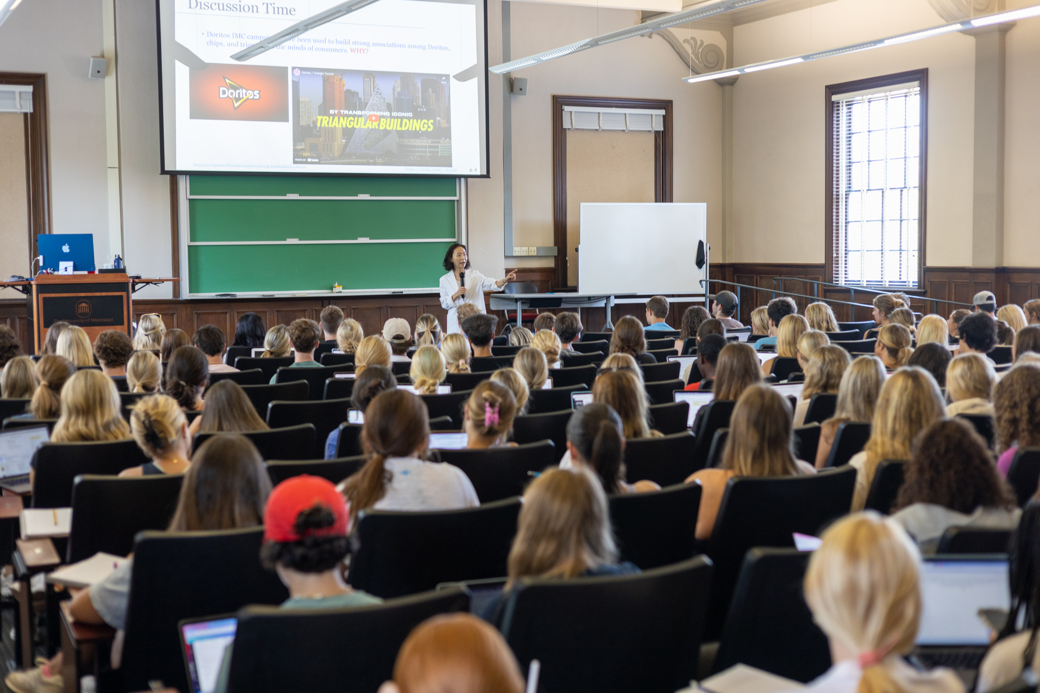 A classroom setting with a presenter discussing with an audience